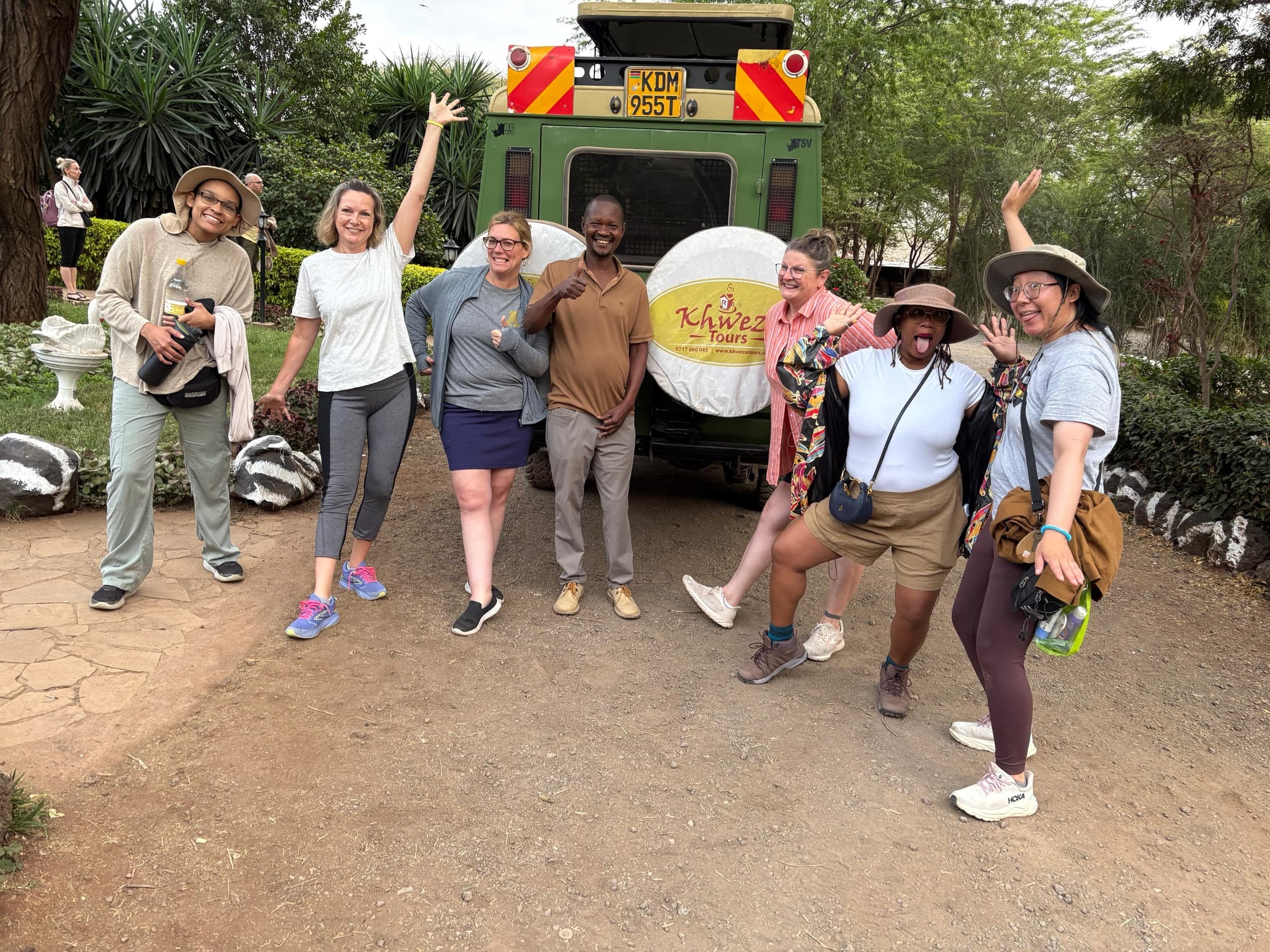 Guests cheering with their Khweza guide behind the safari vehicle
