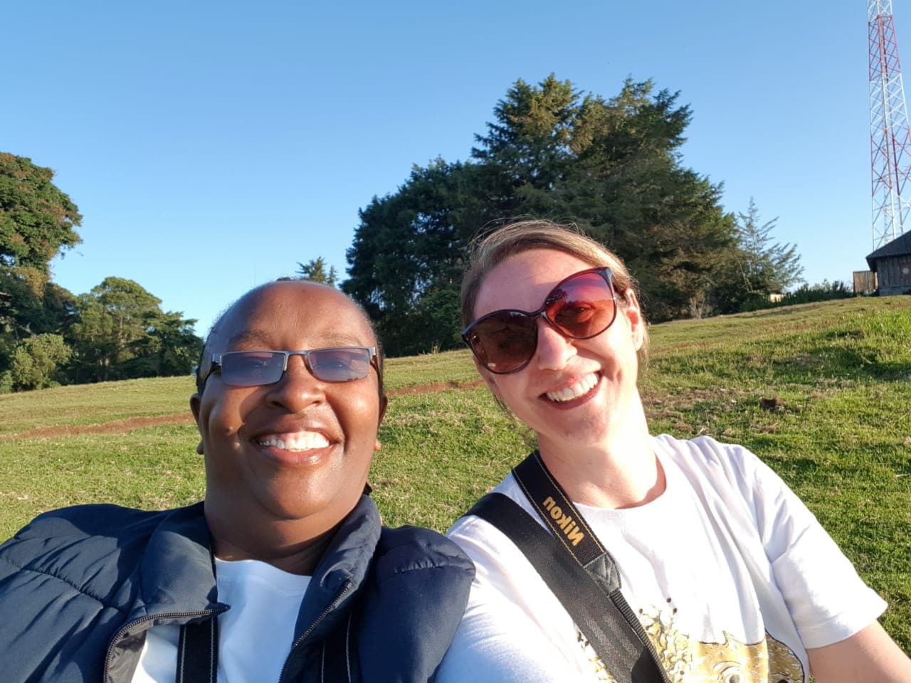 Khweza host and a guest smiling in the Kenyan highlands