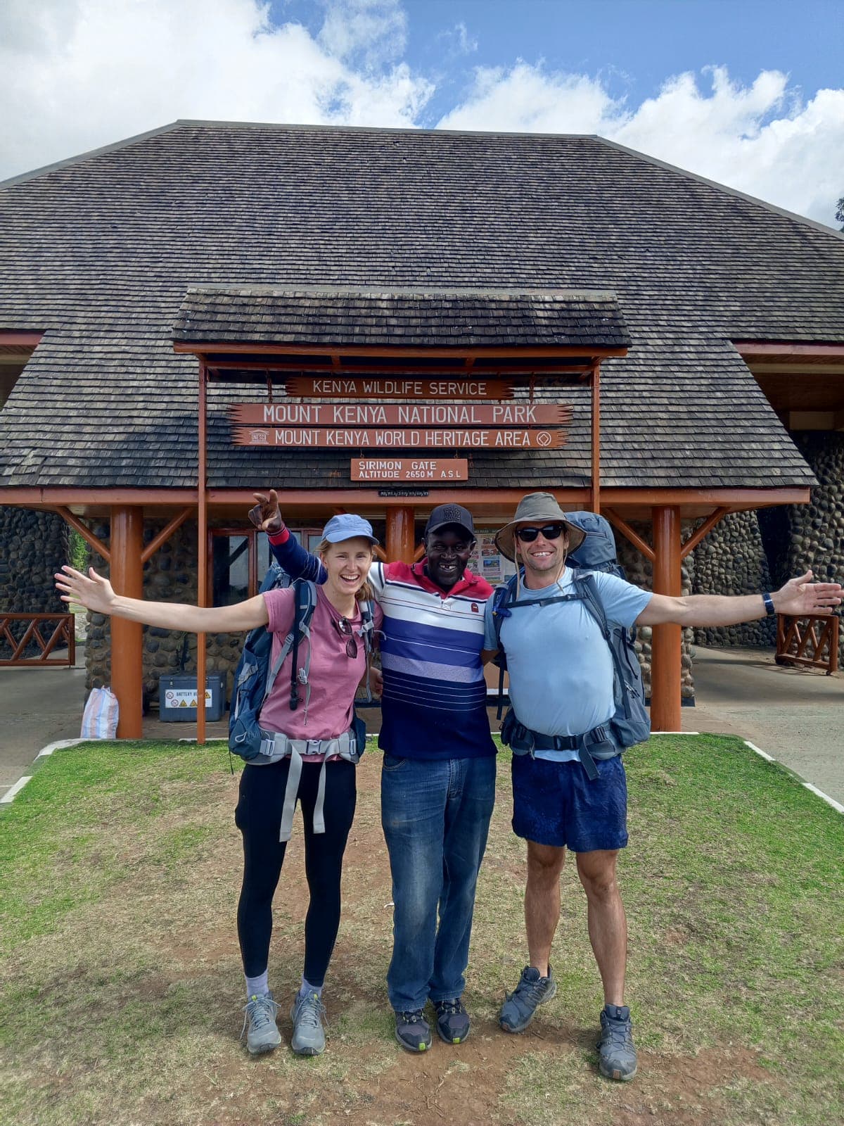 Khweza guide with two hikers at the Mount Kenya National Park gate