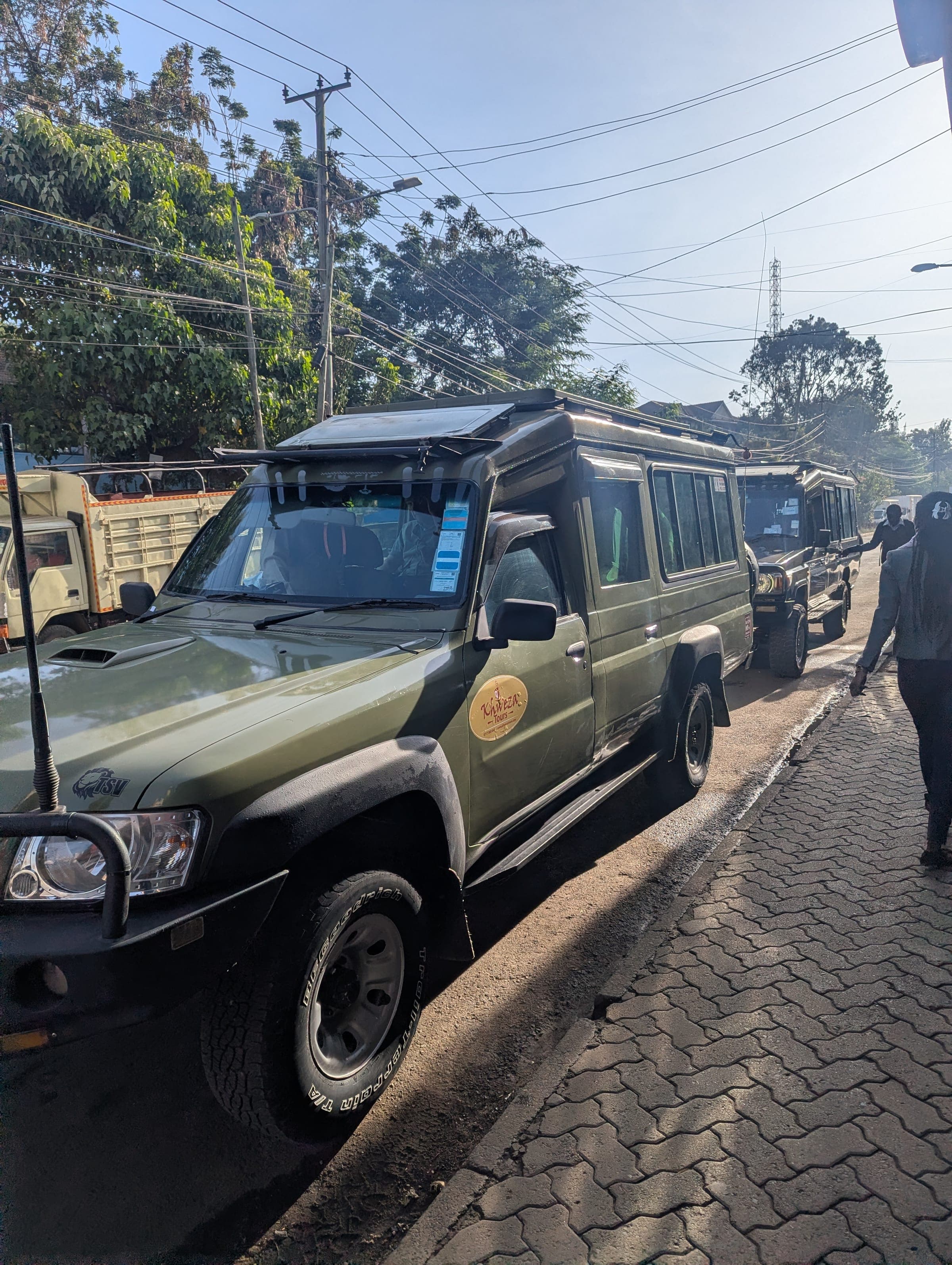 Khweza Tours safari vehicles parked on a Nairobi street